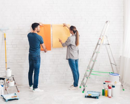 young-happy-couple-choosing-in-what-color-painting-their-new-house.jpg